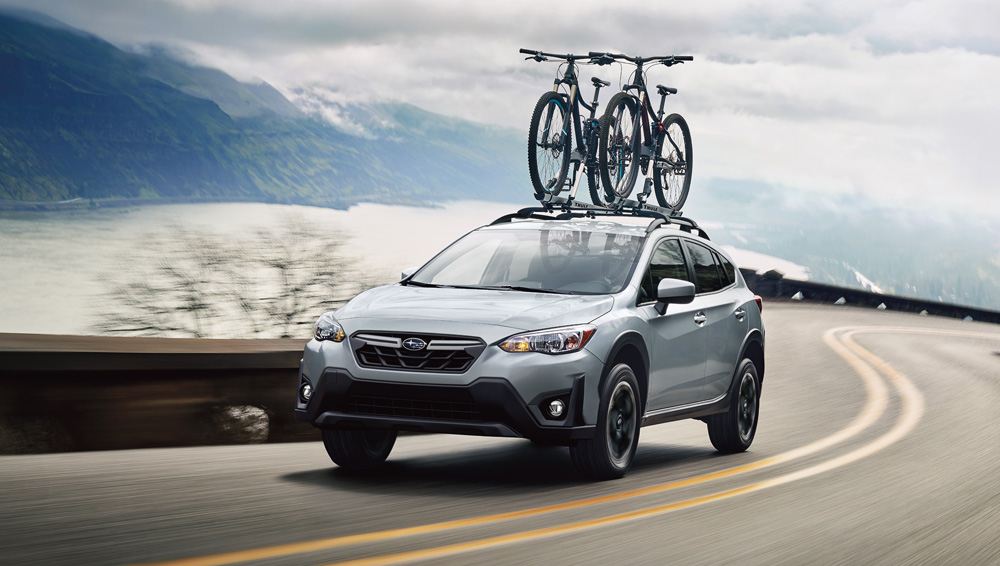 Two bikes on the roof of a grey 2021 Subaru Crosstrek