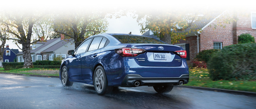 Rear shot of Cosmic Blue 2023 Legacy GT on suburban road.