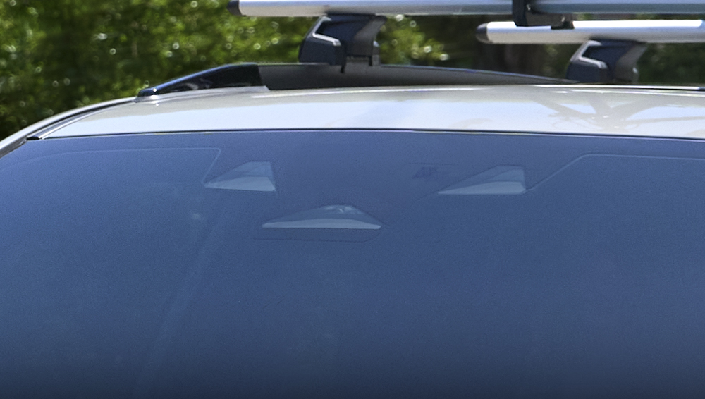 Close up of the Subaru EyeSight system’s stereo and mono wide-angle cameras.
