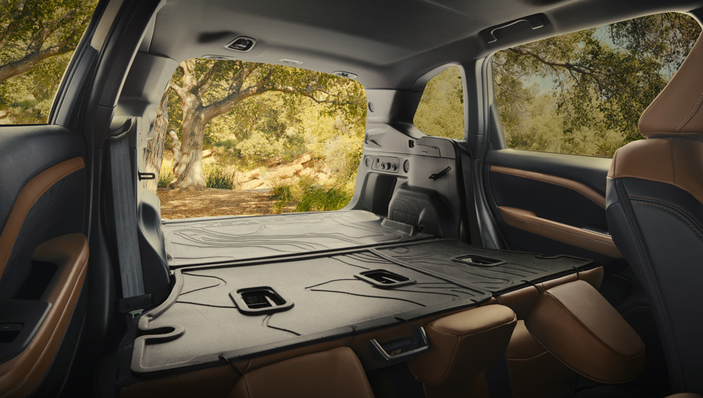 2025 Subaru Forester interior showing cargo space with rear seats folded down.
