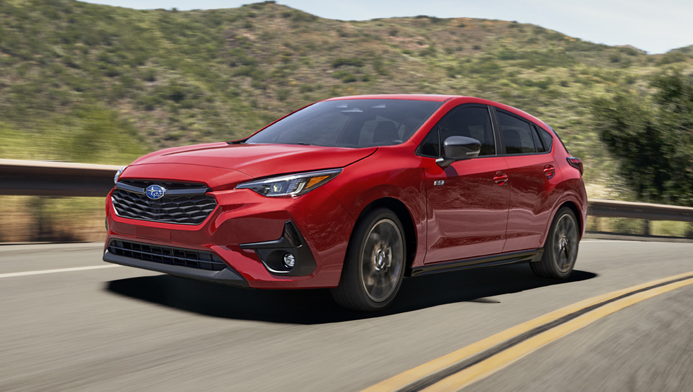 2026 Impreza travelling down a mountain road.