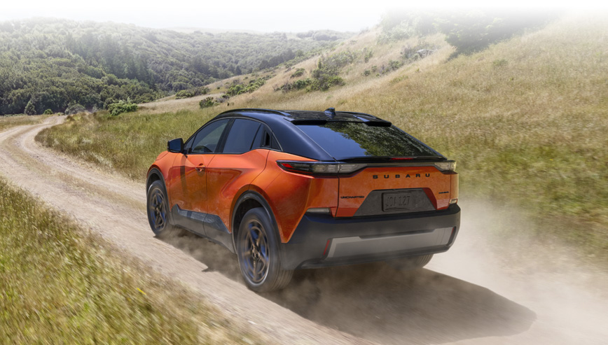 Rear shot of 2026 Uncharted driving on dirt road.