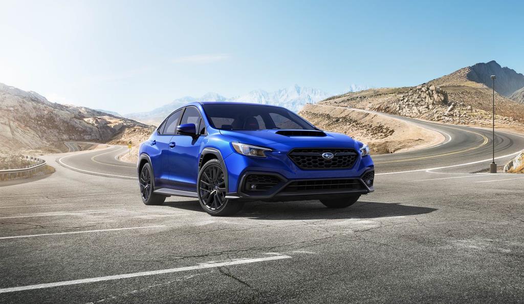 World Rally Blue 2023 WRX Sport-tech stopping at a parking lot.