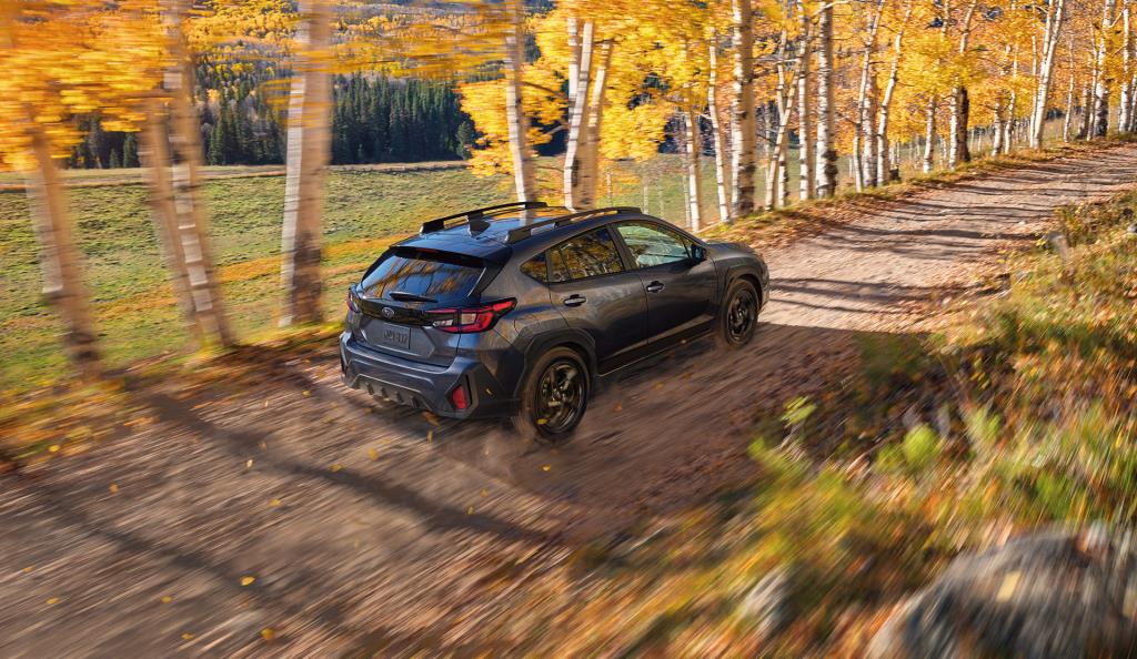 Rear shot of 2026 Crosstrek travelling on dirt road.