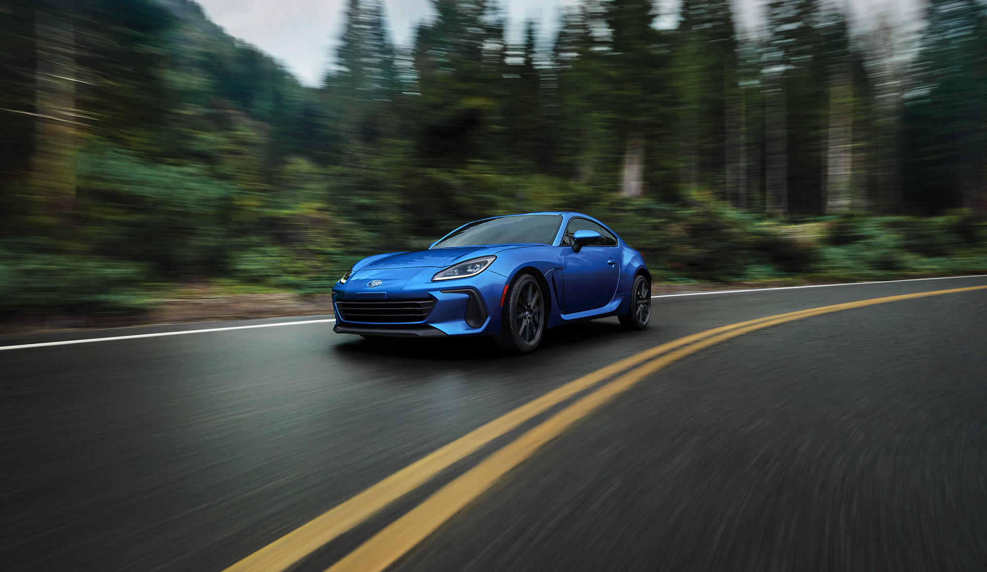 2024 BRZ taking the curve on a road.