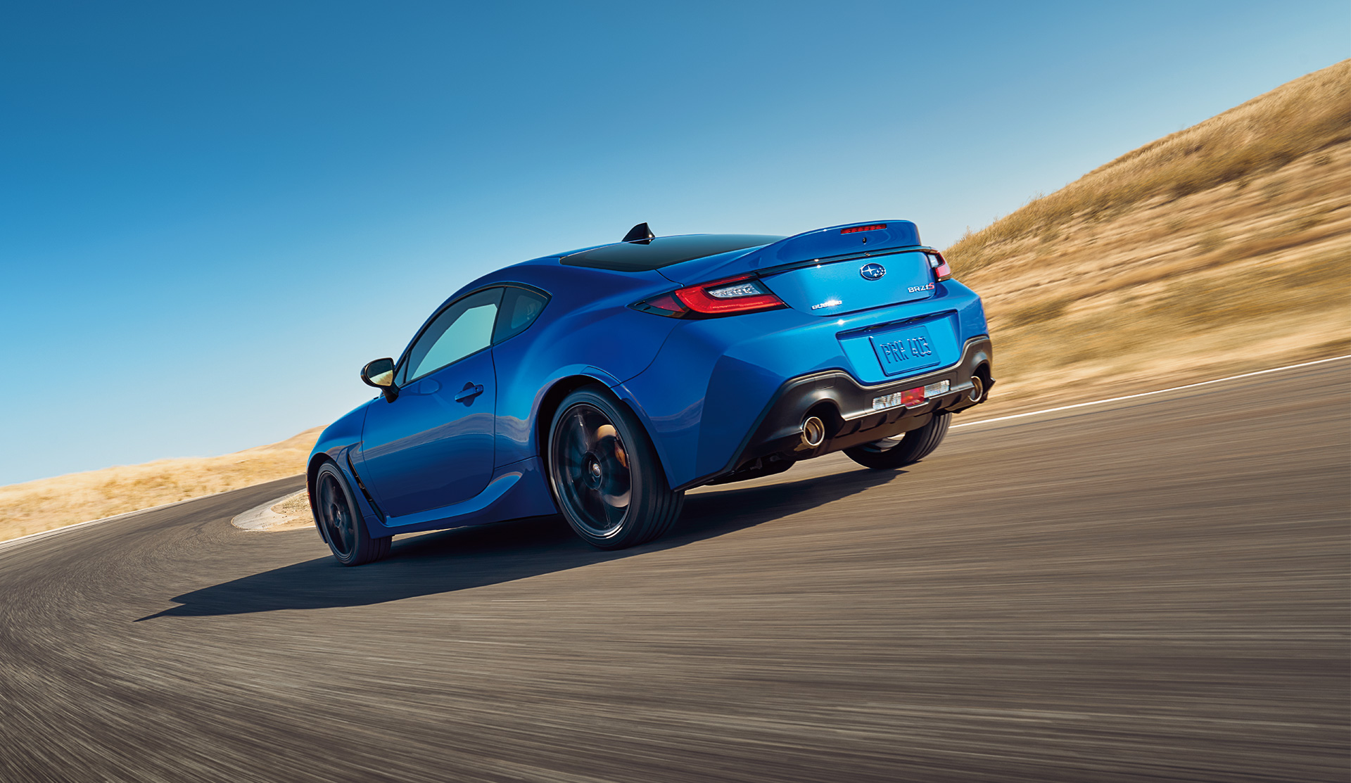 Rear shot of 2024 BRZ tS tackling a corner on racetrack.