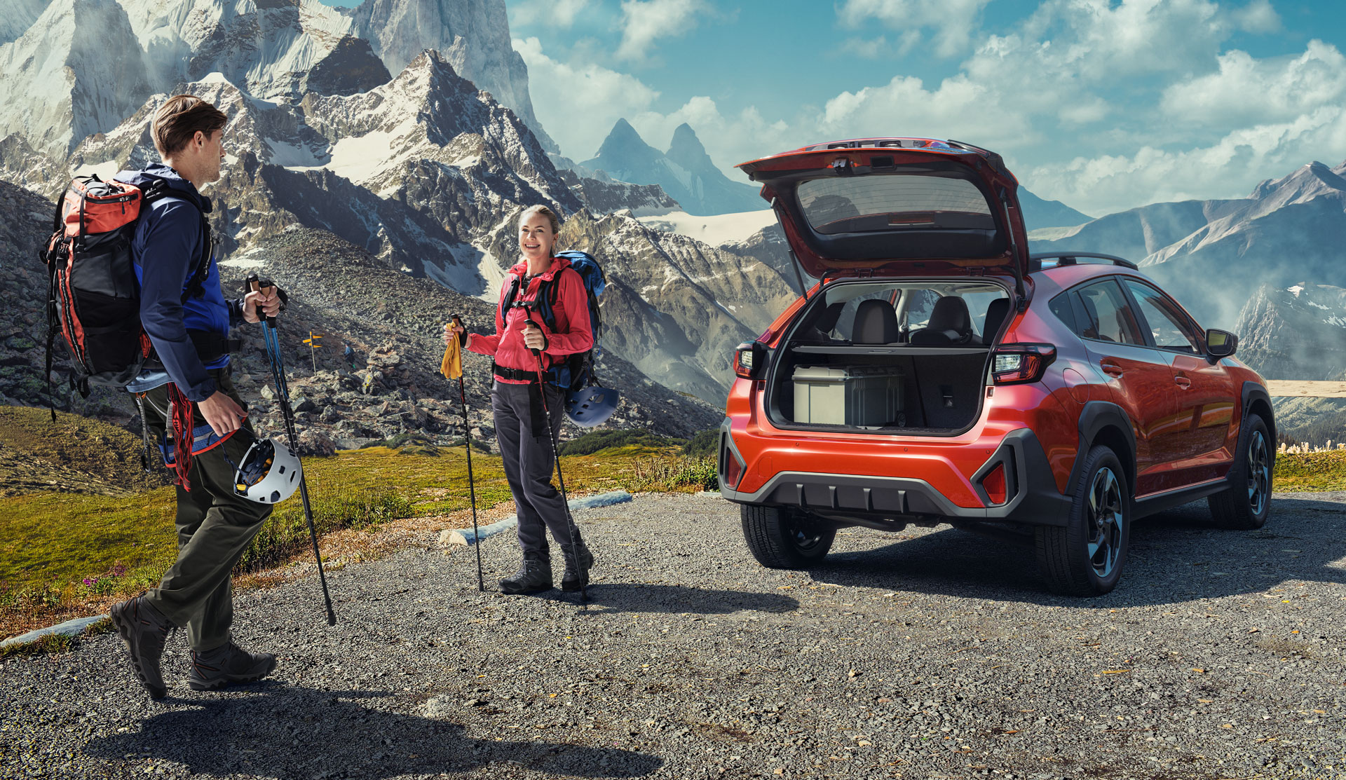 A couple unpacking their 2024 Crosstrek, getting ready for a hike.