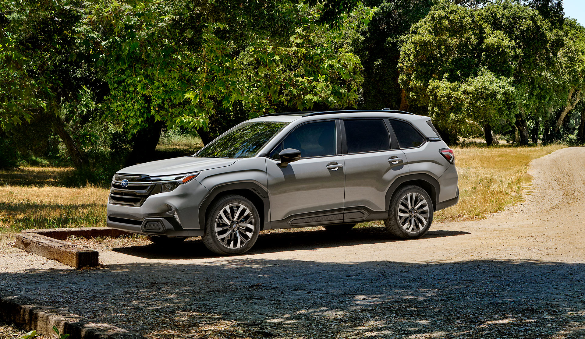 2025 Forester with bicycles on roof, driving on the road.