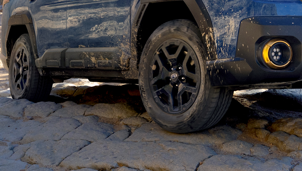 Closeup beneath the 2026 Outback and the road showcasing the generous ground clearance.
