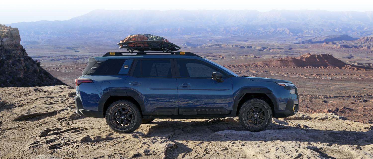 Rear shot of 2026 Outback Wilderness moving across rocky terrain.