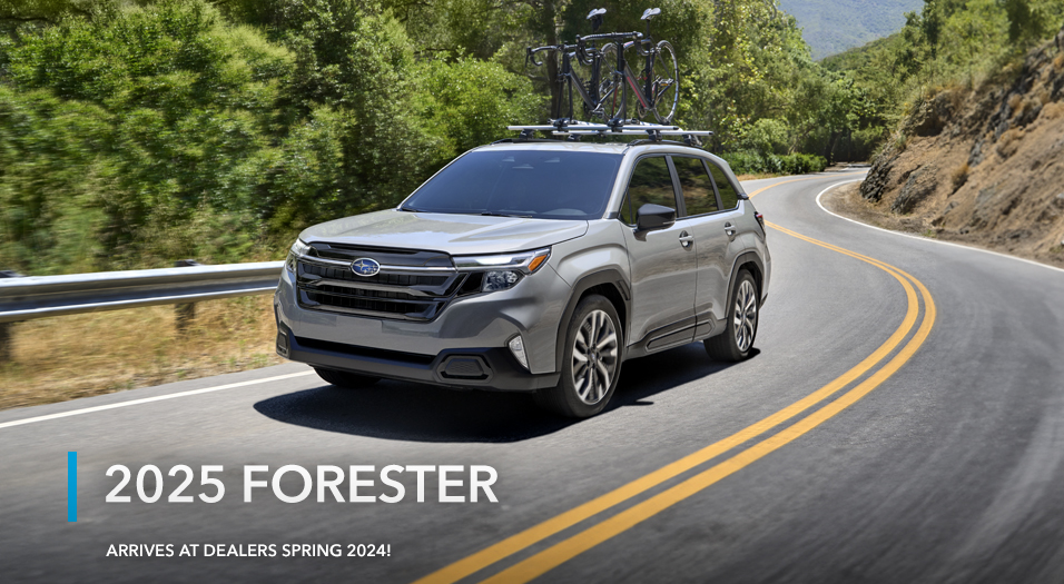 2025 Subaru Forester driving on a rural road.