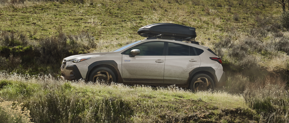 2026 Crosstrek Hybrid driving up the side of a hill.