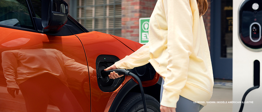 Closeup of a woman plugging in the Uncharted to the charging station.