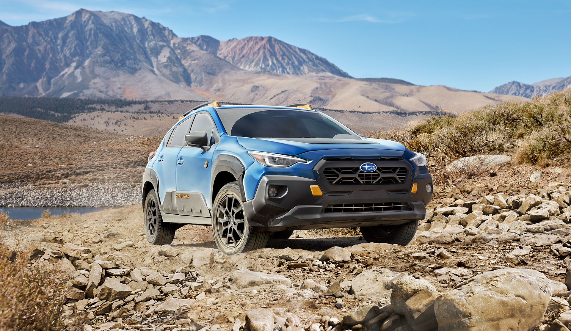 Front shot of 2024 Crosstrek Wilderness stopped on a rocky trail.