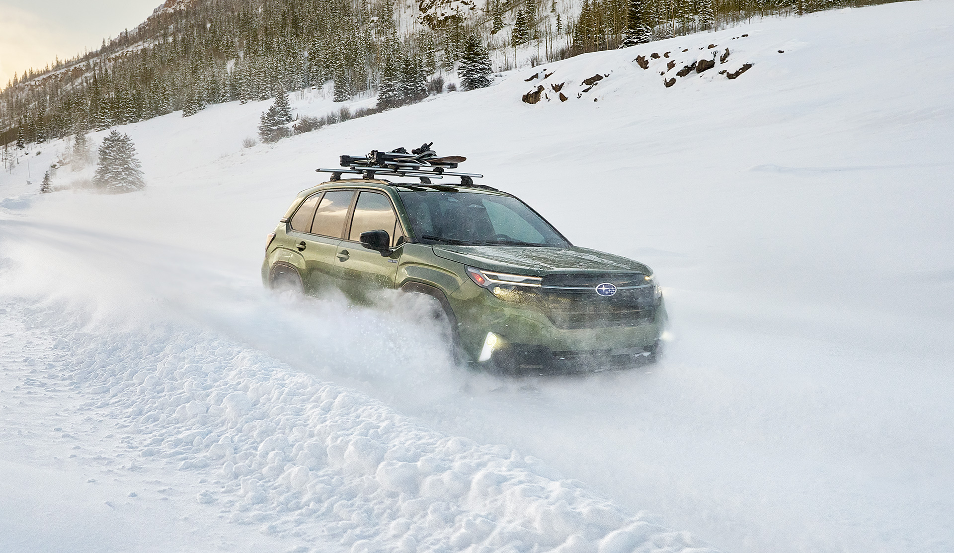 Rear view of the 2025 Forester e-BOXER Hybrid drving on snowy mountaing road