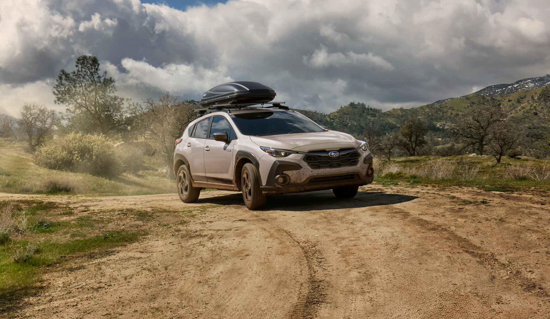 2026 Crosstrek Hybrid driving on dirt trail.